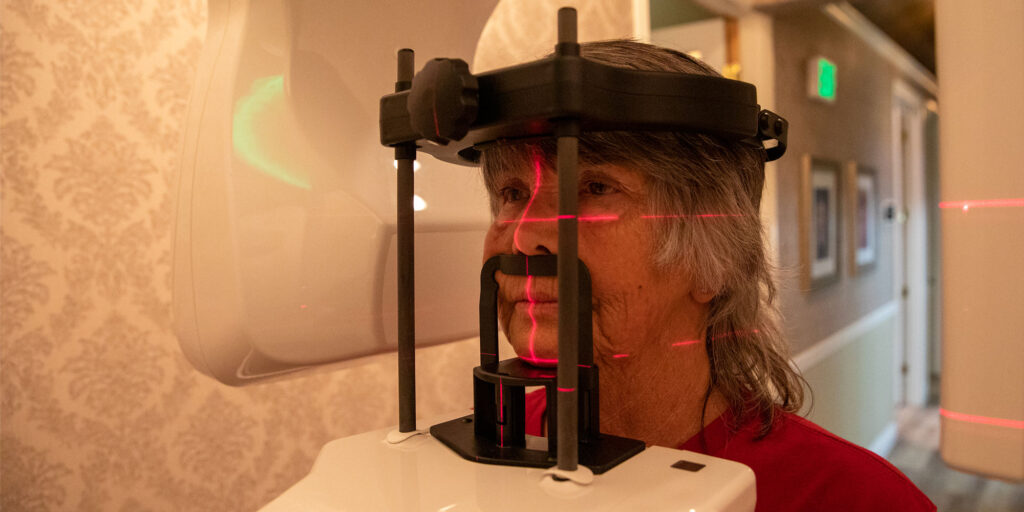 Patient within tan 3D scanning device for dental procedure