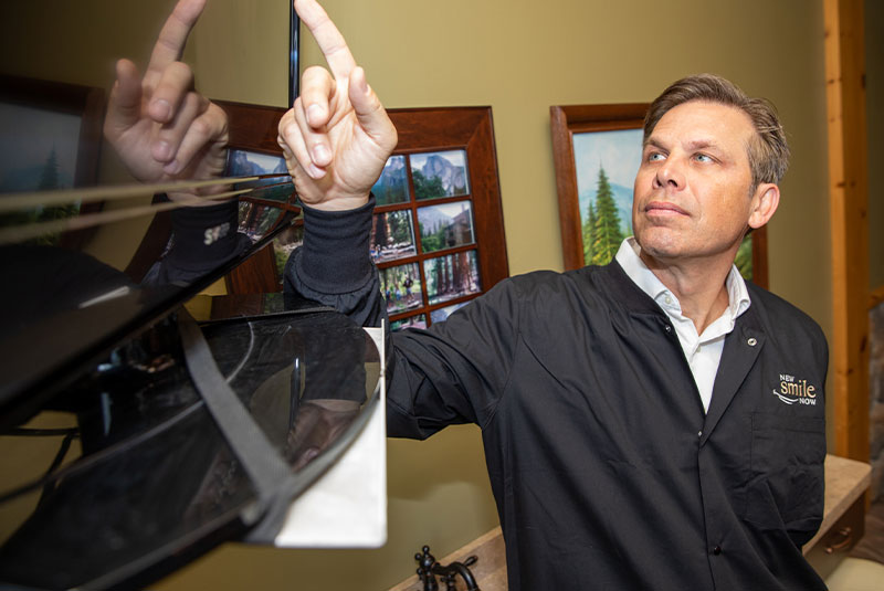 Doctor looking at display image for patients dental procedure