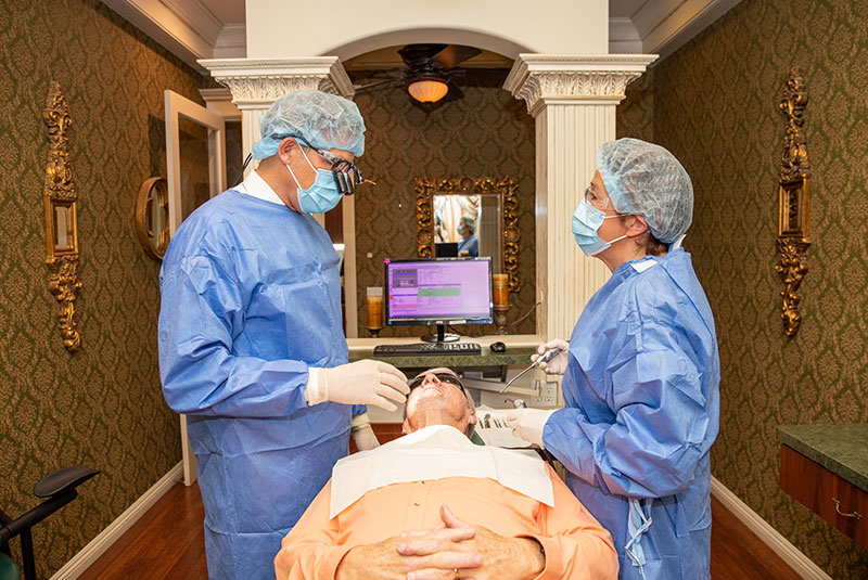 Doctor and assistant prepping for patient's dental procedure